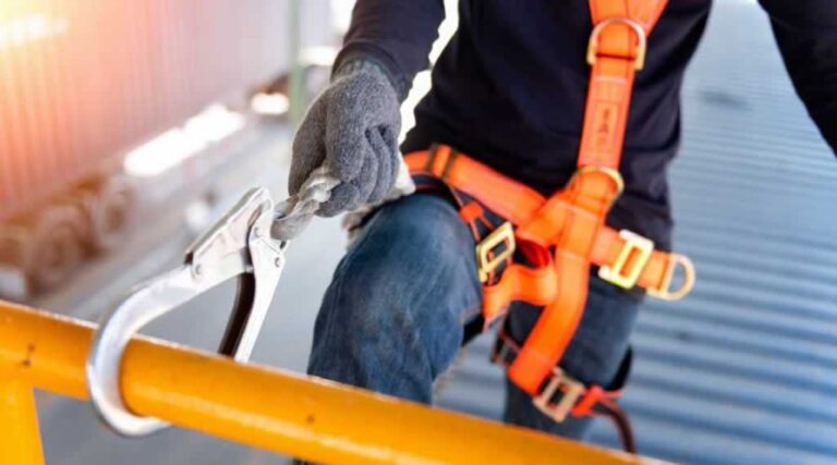 roofing contractor hooking safety rope