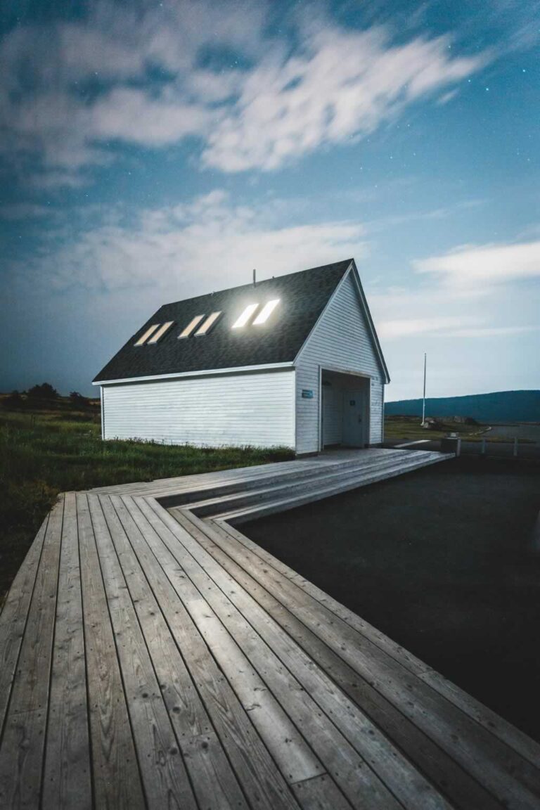 backyard building with board and batten siding and solar panels