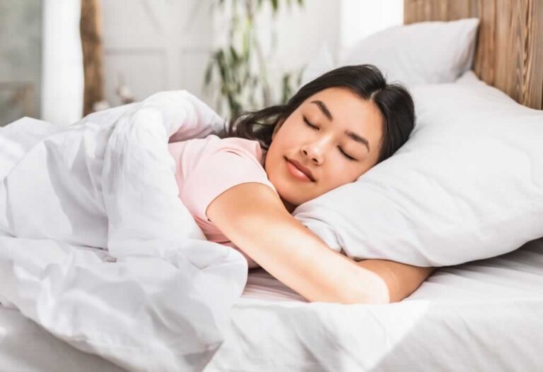 girl sleeping tight on bed