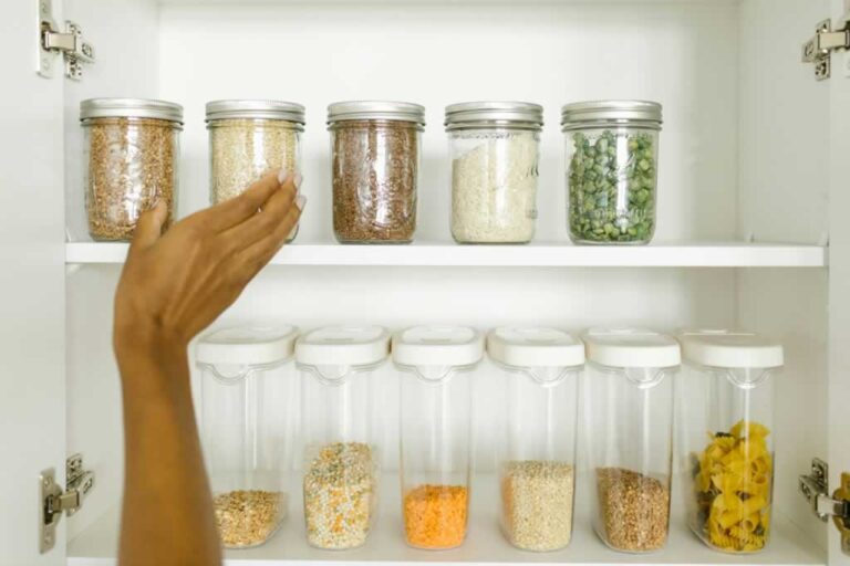 reaching for a jar in perfectly organized cabinet