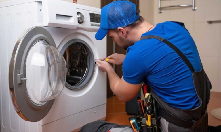technician repairing a washing machine