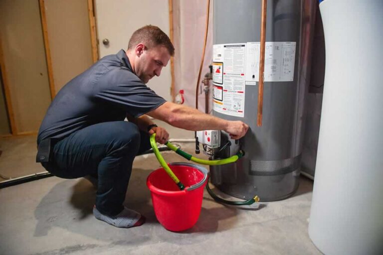 plumber draining a water heater