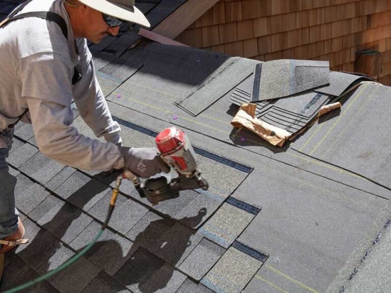 man DIY repairing shingles on the roof