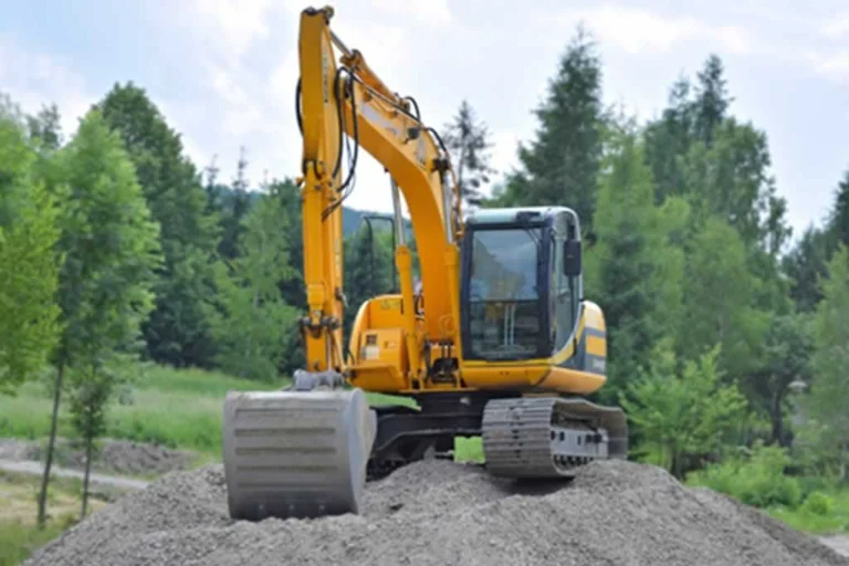 mini excavator on the pile of gravel