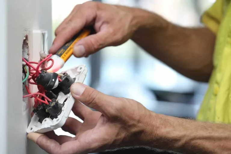 homeowner dismantling a power socket
