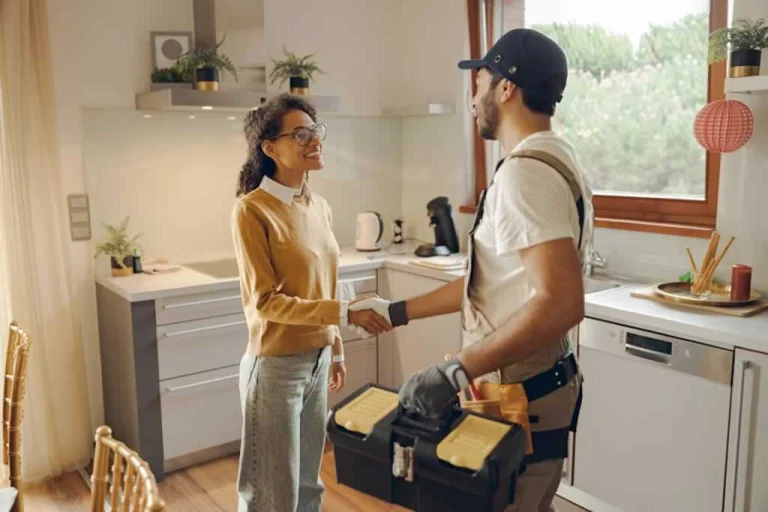 female homeowner shaking hands with the plumber