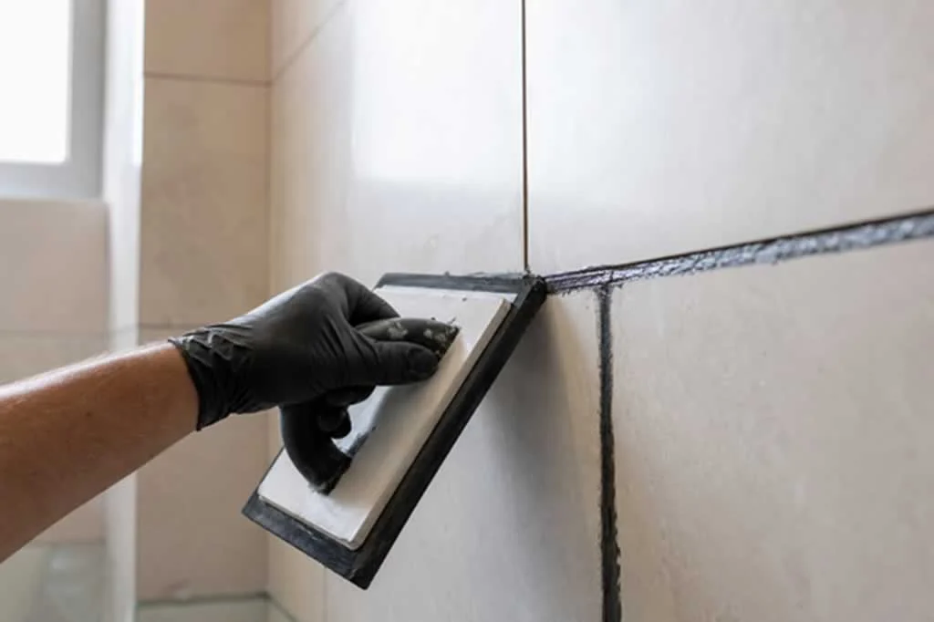 applying new grout with the float