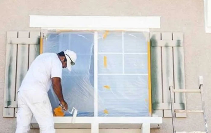contractor painting the exterior of the house