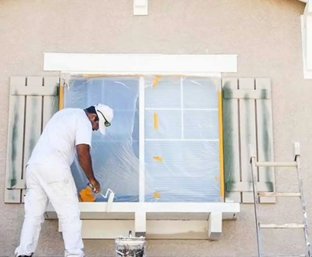 contractor painting the exterior of the house