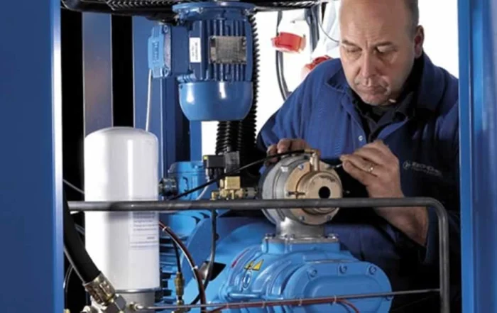 professional doing industrial compressor maintenance