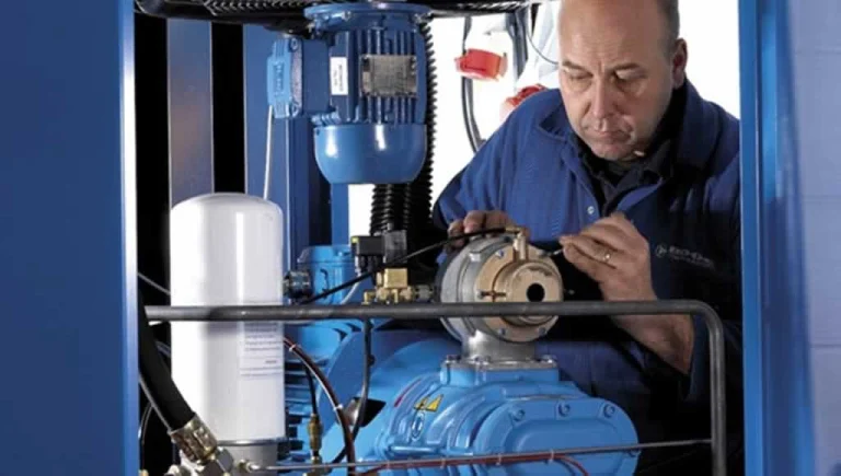 professional doing industrial compressor maintenance