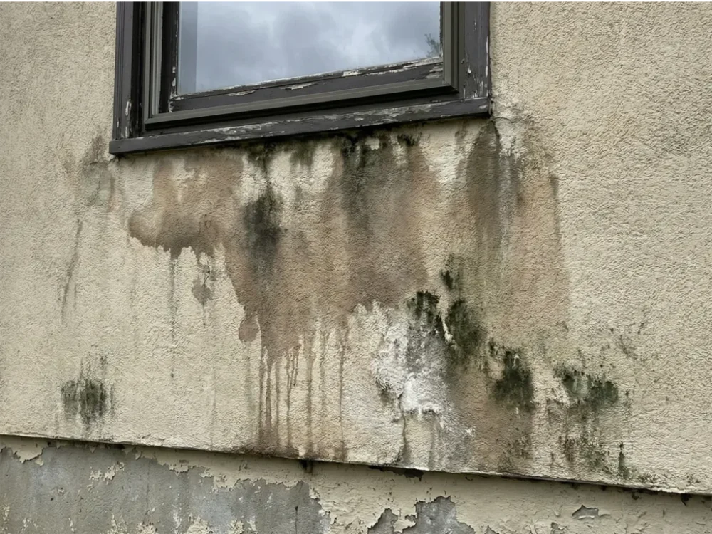 stucco water damage beneath the window
