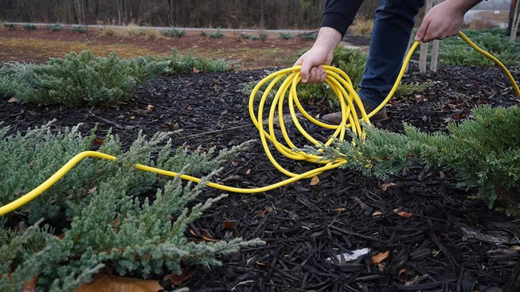 laying extension cord cable in the backyard