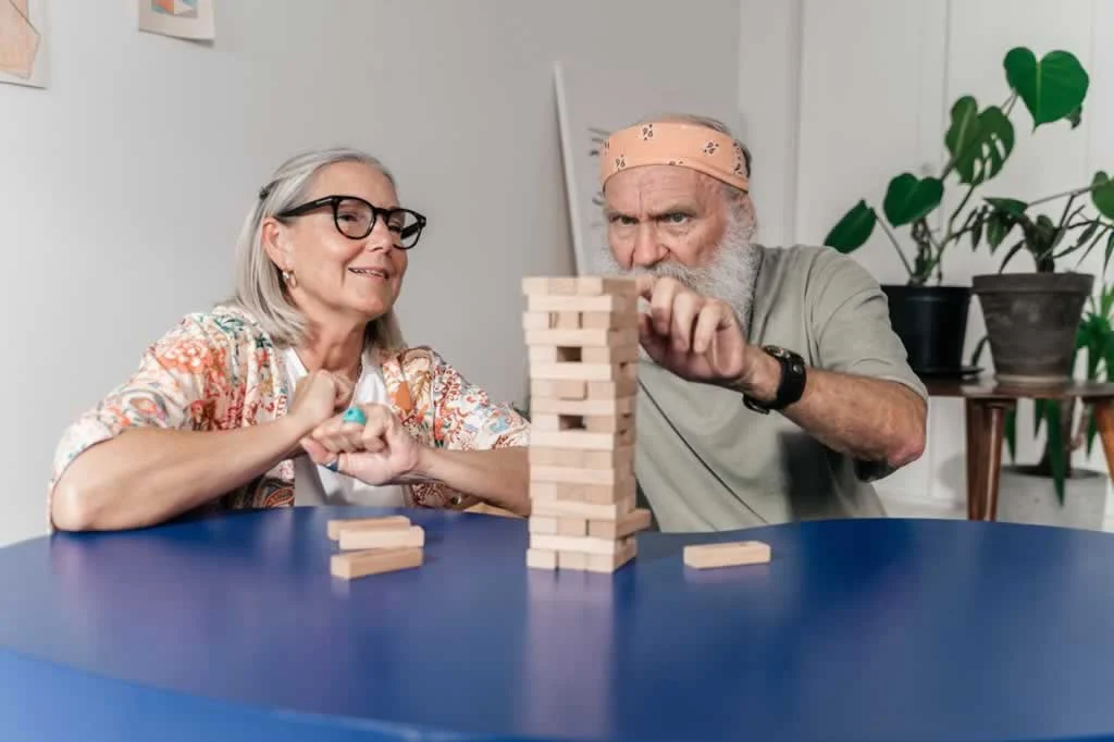 senior couple playing inside the house for seniors