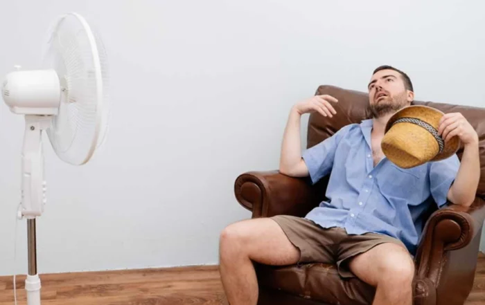 man cooling in front of a fan with AC down