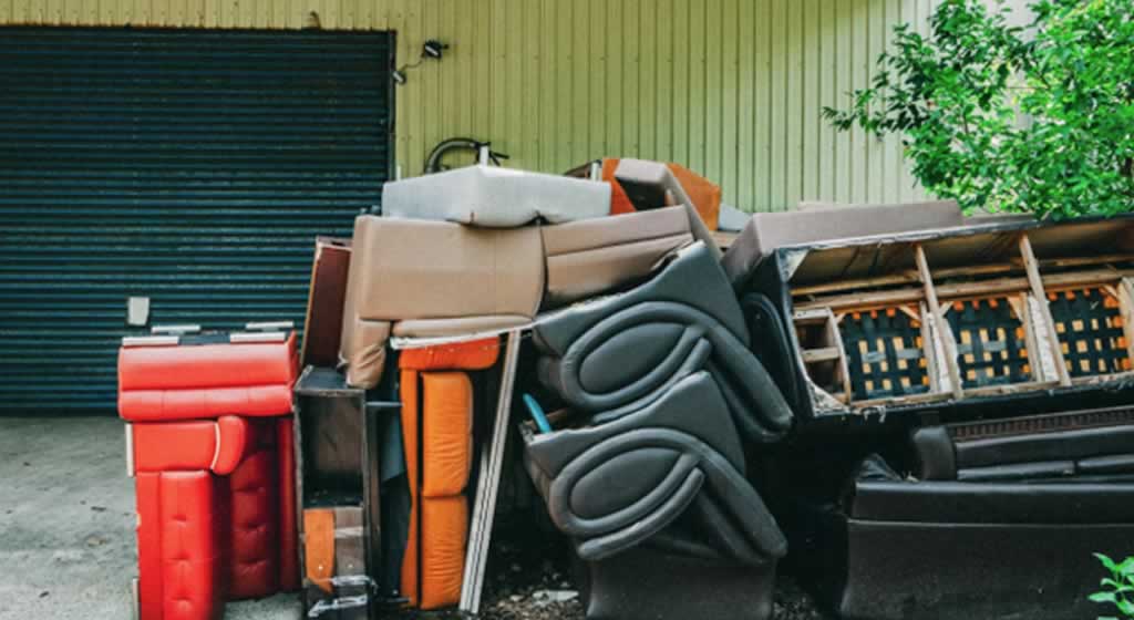 mattresses and beds in front of the garage
